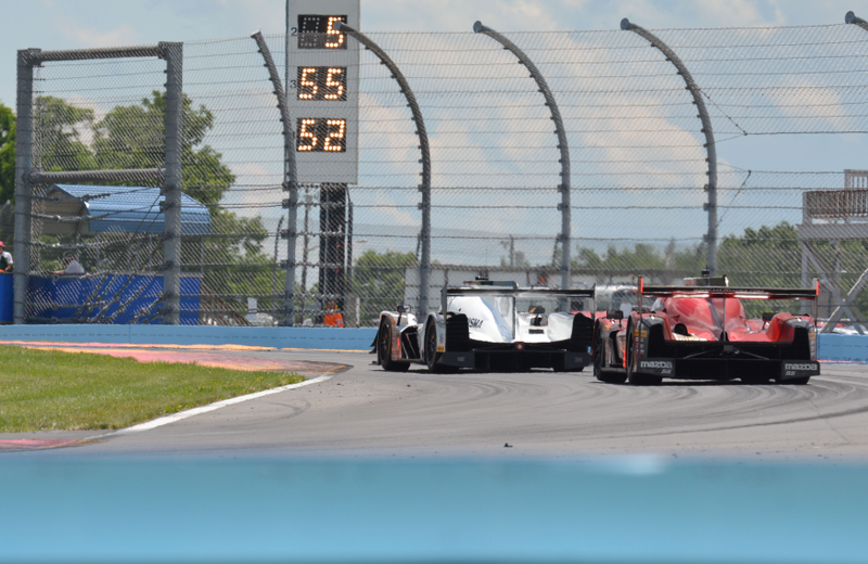 Mustang Sampling Racing Cadillac DPi leads the Mazda Motorsports Mazda DPi through the chicane